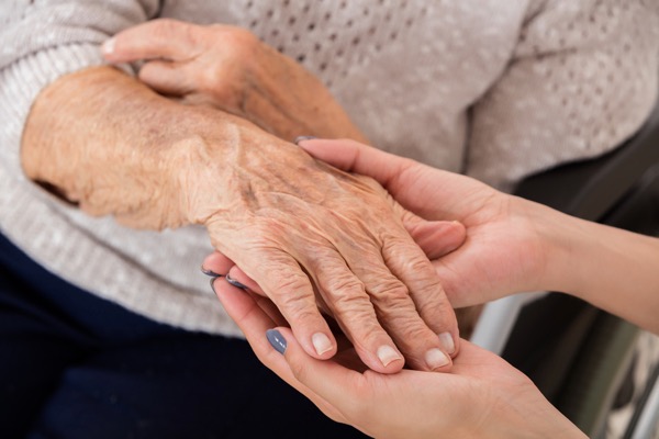 Hosford Health Clinic osteopath assessing arthritis in senior womans hand